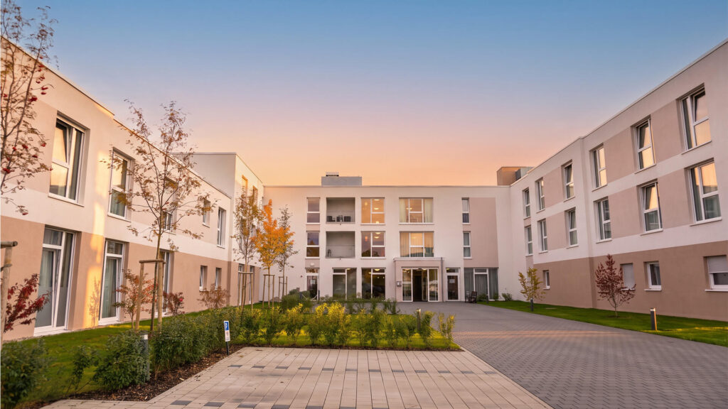 Servicehaus Sonnenhalde Tengen: Innenhof mit Eingangsbereich und Gartenanlage in der Abenddämmerung